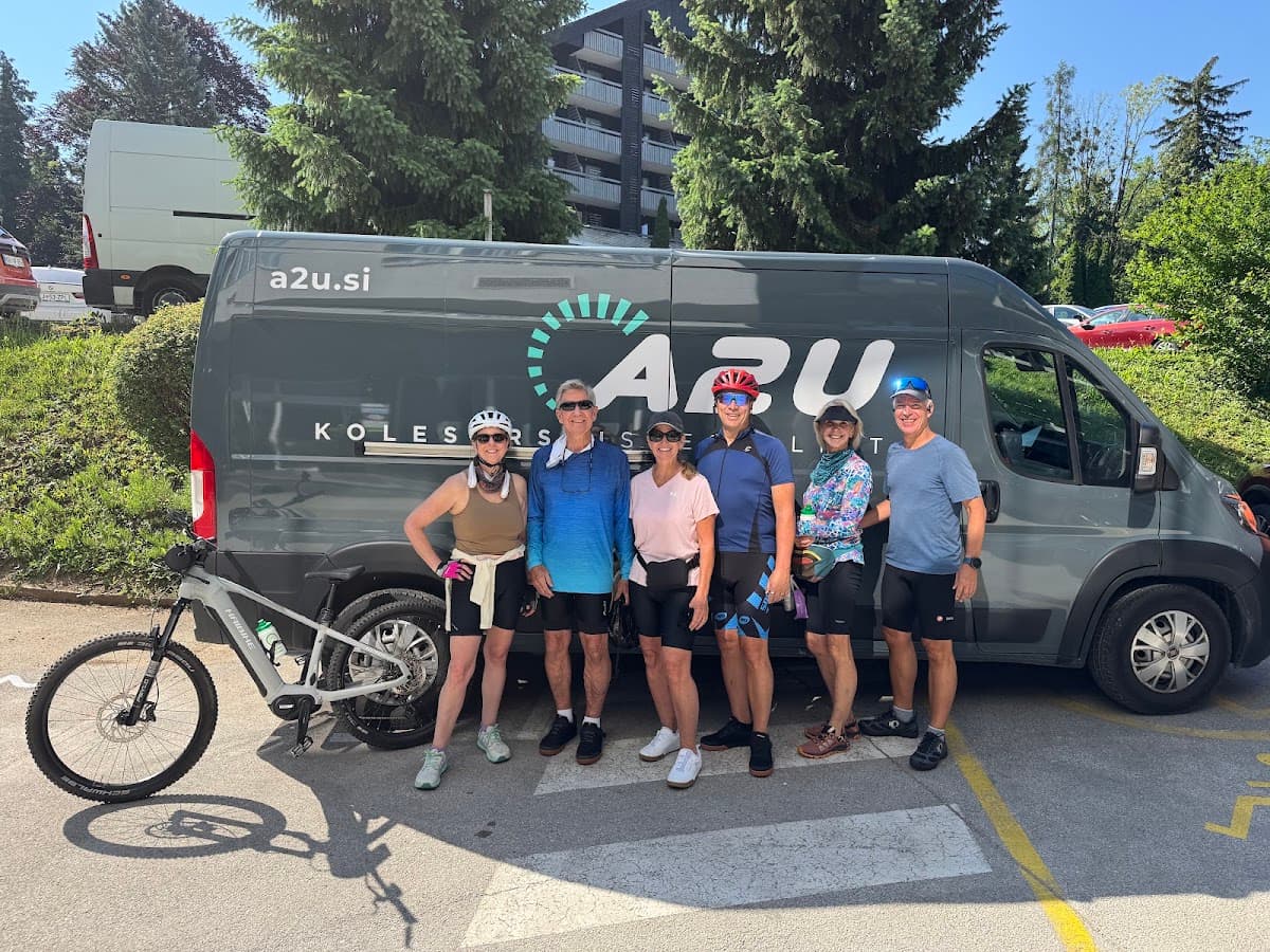 Cyclists standing in front of a branded van with a bicycle