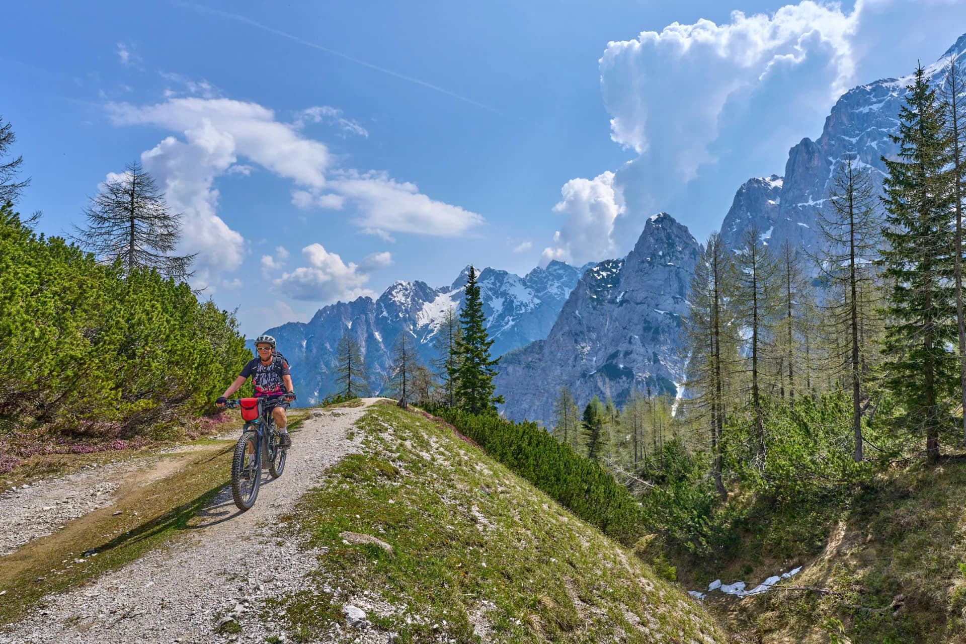 cheerful active senior woman on a E mountain bike tour at Vršič Pass in the Triglav National Park, Julian Alps above Kranska Gora in Slovenia