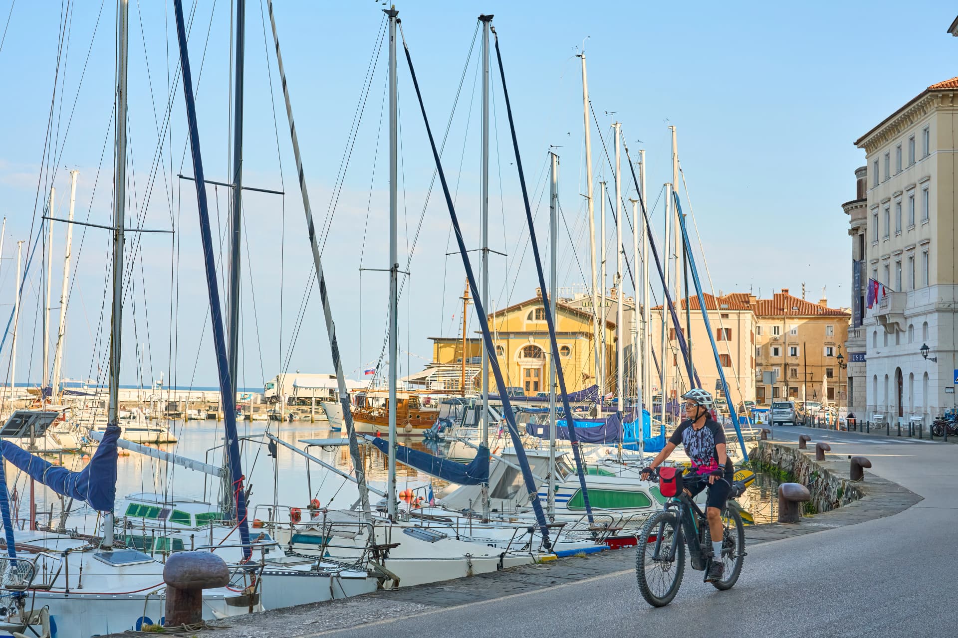 beautiful senior woman cycling in downtown Piran at the Adriatic sea in Slovenia, Europe
