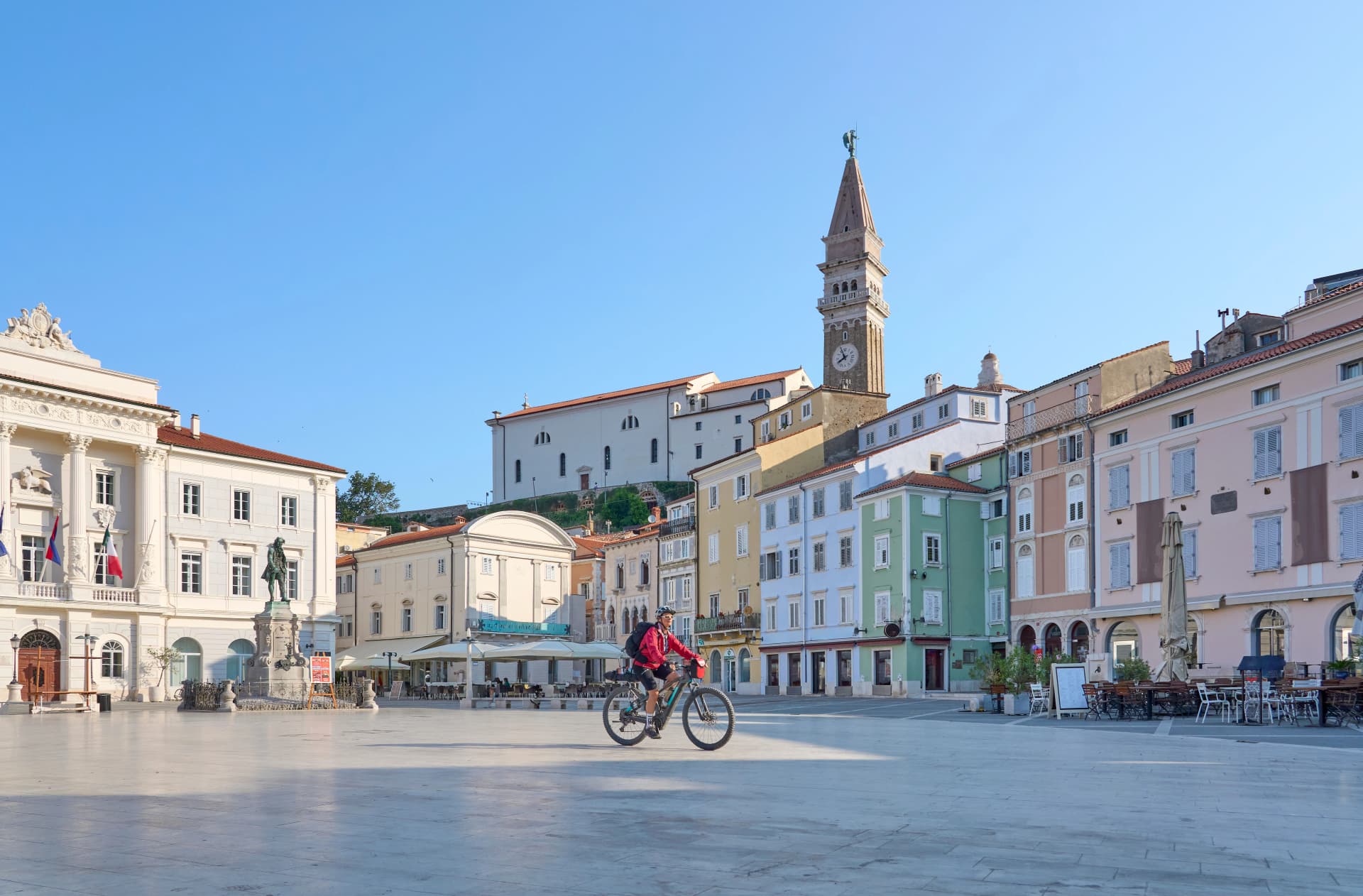 beautiful senior woman cycling in downtown Piran at the Adriatic sea in Slovenia, Europe