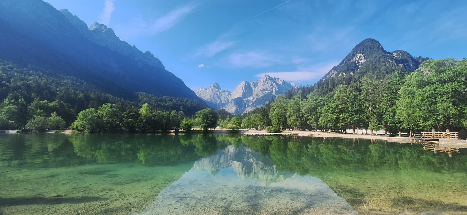 Jasna Lake with clear turquoise water and mountain reflections below the Julian Alps