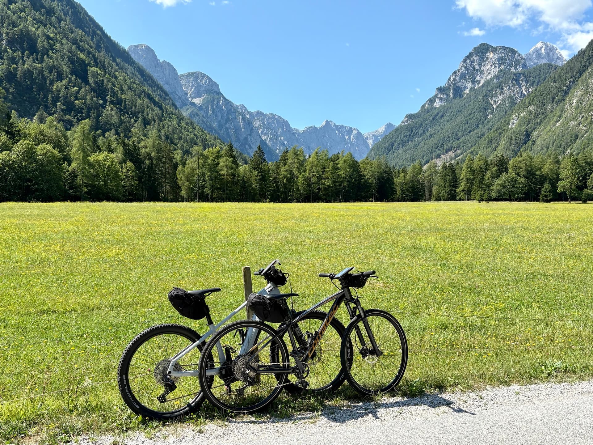 Bikes parked in meadow below the Julian Alps