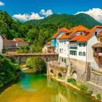 cityscape of skofja loka slovenia view of the capuchin bridge over the selska sora river in the old city center stockpack adobe stock scaled